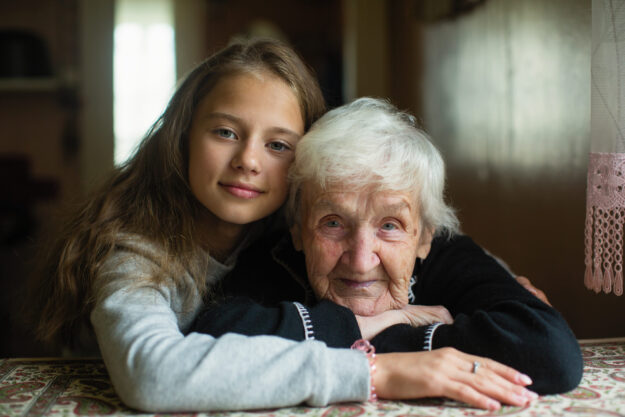 Child,Of,Eleven,With,His,Grandmother,Posing,For,Portrait.